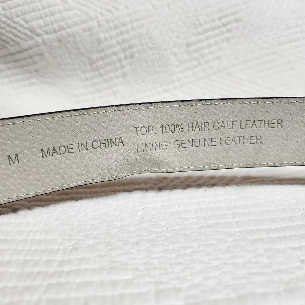 100% calf hair leather‎ dark brown, white spotted belt.